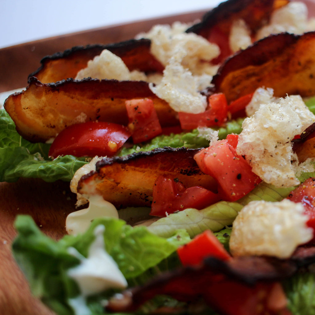 Lettuce boats filled with bacon, chopped tomatoes, and crumbled chicharrones