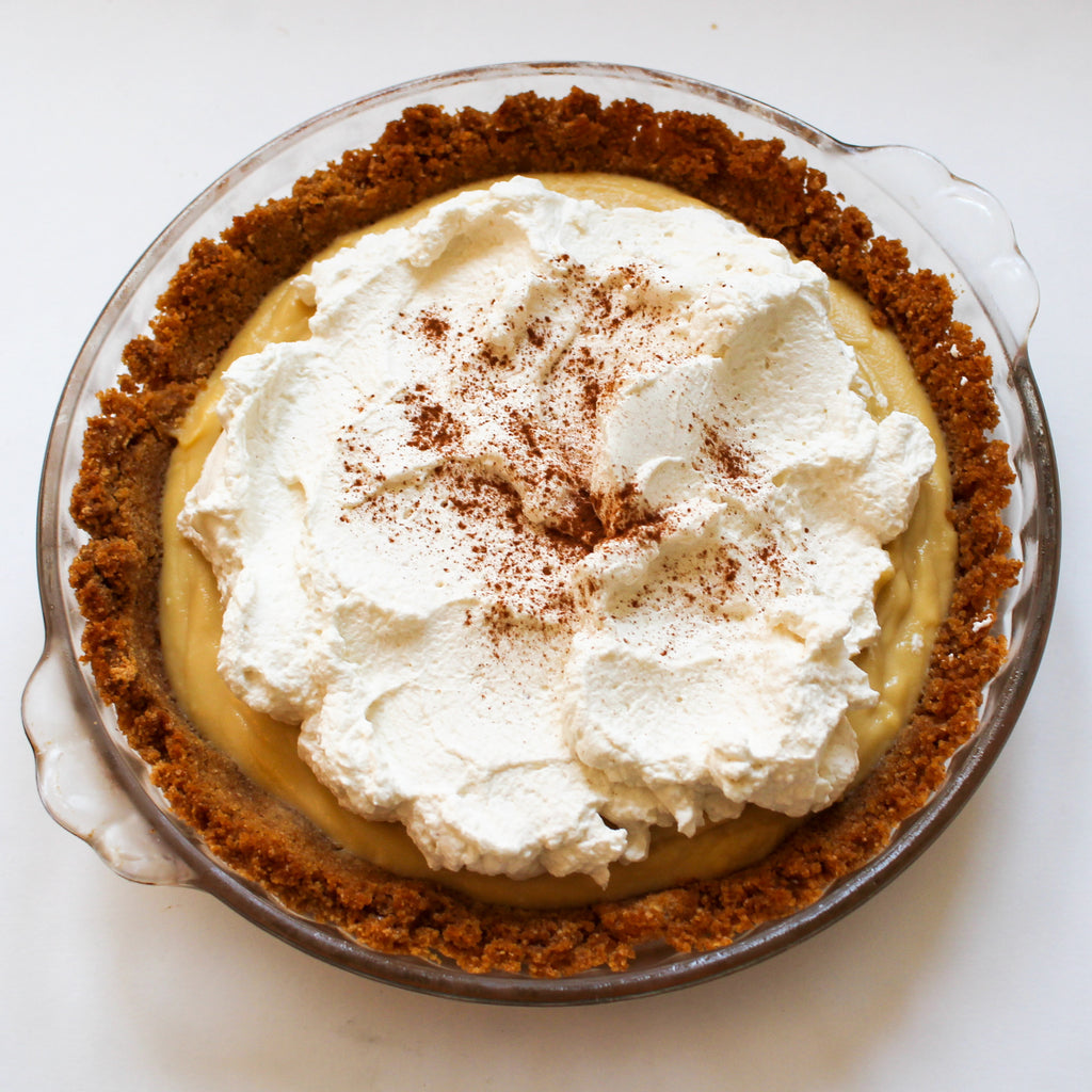 Maple custard pie in graham cracker and pork rind cookie crust with whipped cream